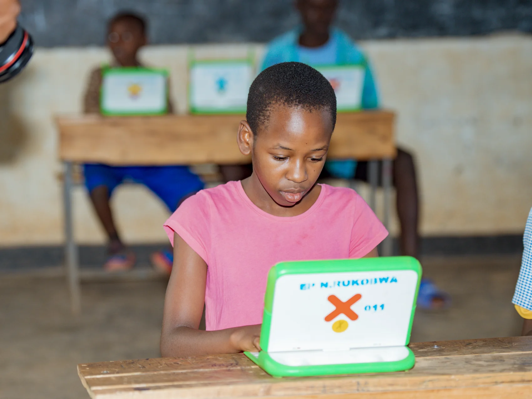 A student works on a OLPC laptop