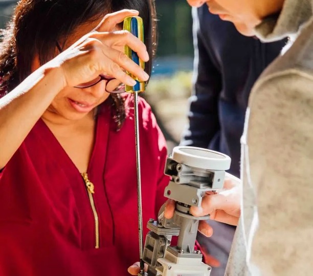 Woman working on a piece of equipment