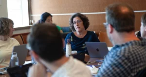 Sonia Jorge speaks in a meeting with other research grantees